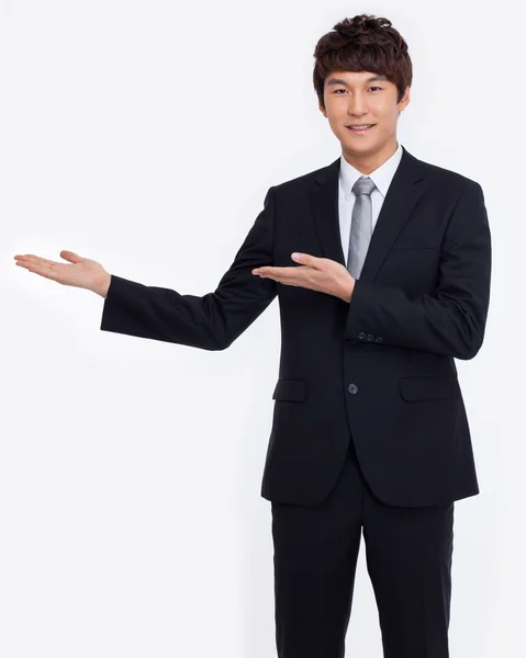 Young Asian business man showing something — Stock Photo, Image