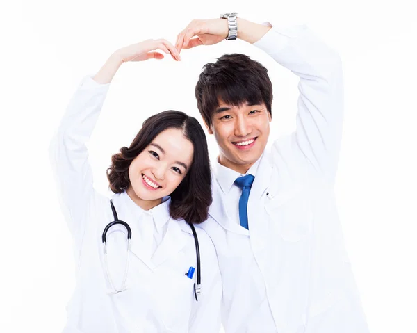 Young Asian doctors showing heart shape. — Stock Photo, Image