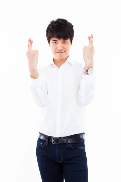Joven asiático hombre mostrando suerte signo . — Foto de Stock
