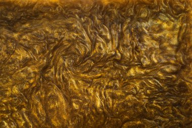 Sıvı altının dokusu ve parlak pigmentler. Dalgaların soyut altın dokusu, girdaplar. Altın likit akrilik boya. Modern tasarım ögesi. 