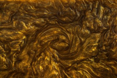 Sıvı altının dokusu ve parlak pigmentler. Dalgaların soyut altın dokusu, girdaplar. Altın likit akrilik boya. Modern tasarım ögesi. 