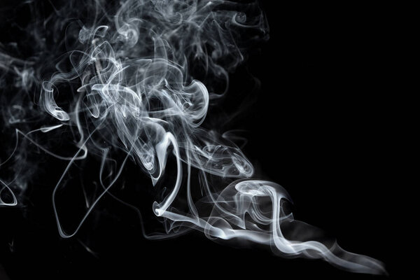 Twisted plumes of smoke, smoke movement on a black background. Abstract smoke lines 