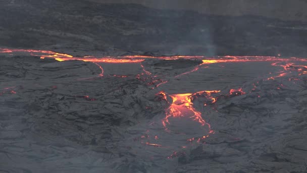 Red-hot volcanic lava spreads across a valley in Iceland after a volcanic eruption. — Stock Video
