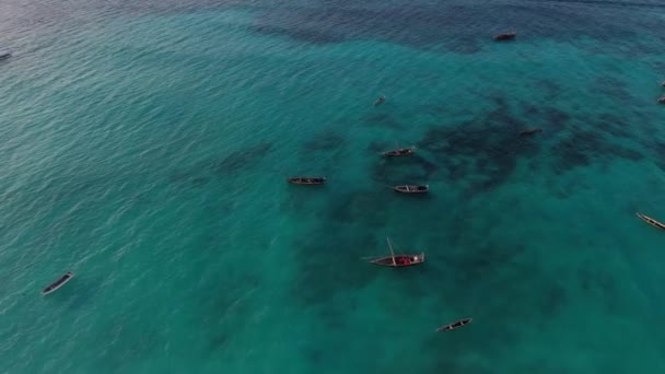 Zanzibar. Tanzanie. Vue aérienne des bateaux de pêche flottant sur les vagues turquoise de l'océan Indien. Drone point vue du dessus séquences 4K. — Video