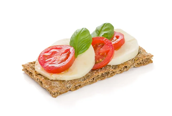 Crispbread with tomato and mozzarella — Stock Photo, Image