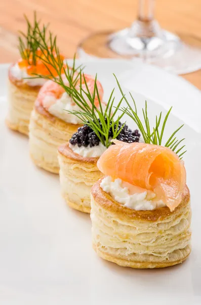 Pastries with salmon, caviar and shrimp — Stock Photo, Image