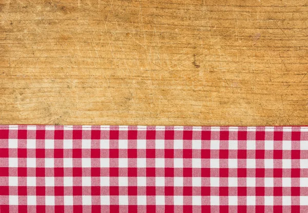 Fundo de madeira rústico com uma toalha de mesa quadriculada vermelha — Fotografia de Stock