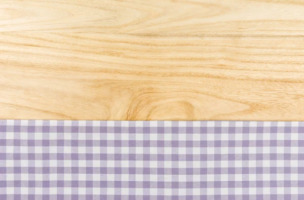 Purple checkered table cloth on a wooden background — Stock Photo, Image