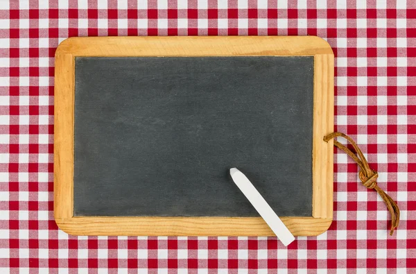 Empty blackboard with chalk on a red checkered table cloth — Stock Photo, Image