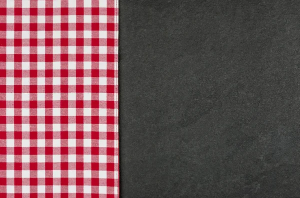 Slate plate with a red checkered tablecloth — Stock Photo, Image