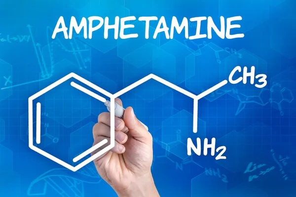 Hand with pen drawing the chemical formula of amphetamine — Stock Photo, Image