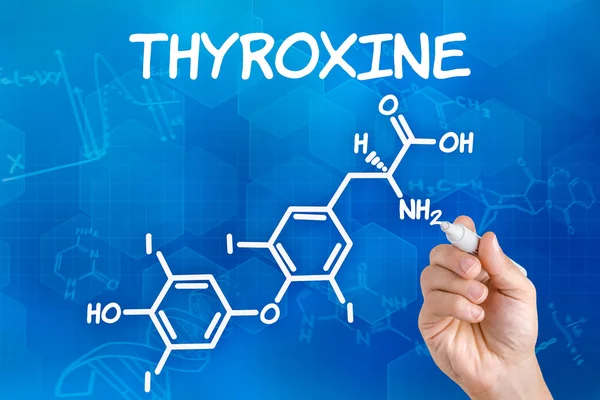 Hand with pen drawing the chemical formula of thyroxine — Stock Photo, Image