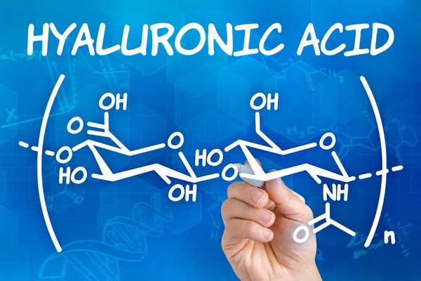 Hand with pen drawing the chemical formula of hyaluronic acid — Stock Photo, Image