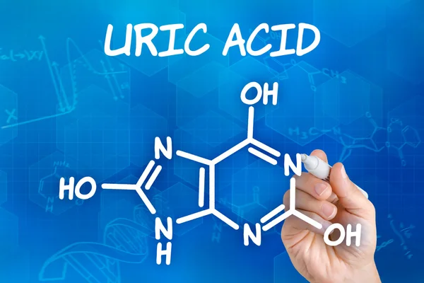 Hand with pen drawing the chemical formula of uric acid — Stock Photo, Image