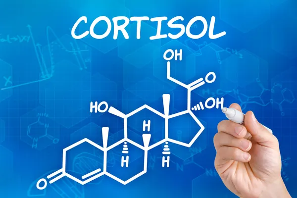 Ruka s perem kreslení chemický vzorec kortizolu — Stock fotografie