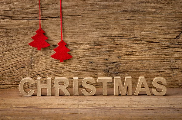 The word christmas in front of a rustic background — Stock Photo, Image