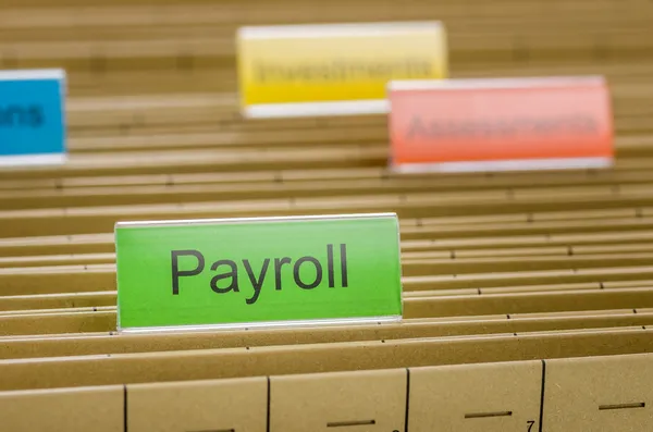 Hanging file folder labeled with Payroll — Stock Photo, Image