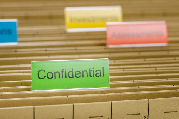 Hanging file folder labeled with Confidential — Stock Photo, Image