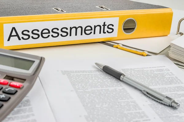 Folder with the label Assessments — Stock Photo, Image