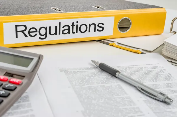 Folder with the label Regulations — Stock Photo, Image