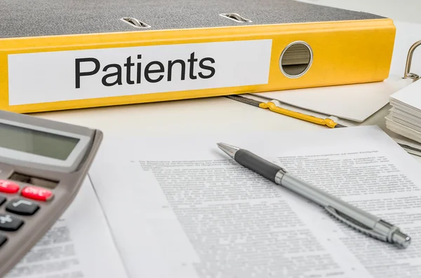 Folder with the label Patients — Stock Photo, Image
