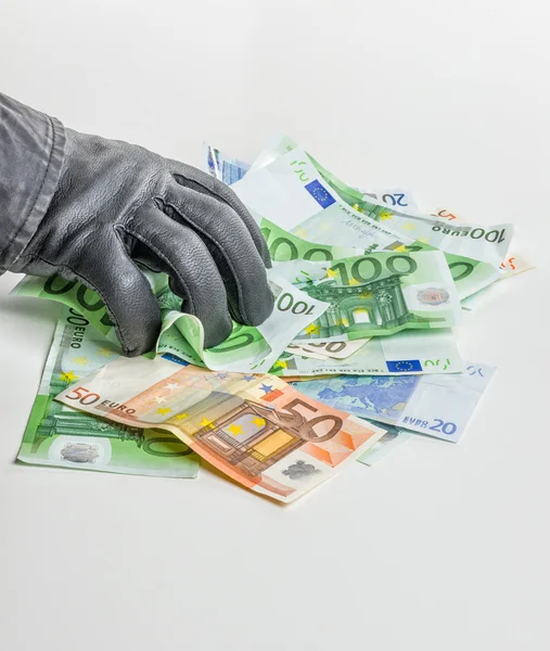 Thief with leather glove is grabbing some bills — Stock Photo, Image