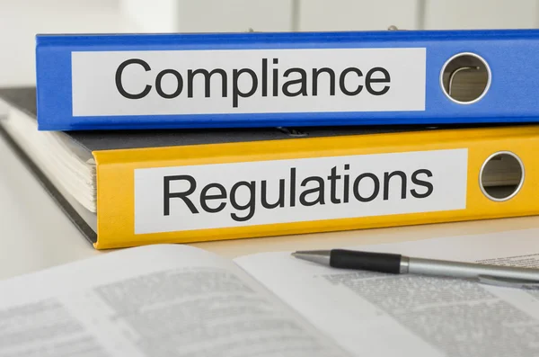 Folders with the label Compliance and Regulations — Stock Photo, Image