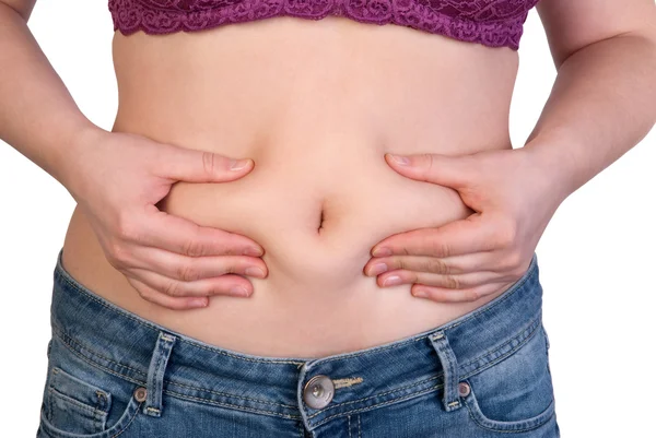 Woman measuring her belly fat with her hands — Stock Photo, Image