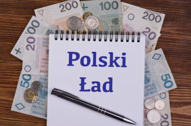Polonya 'daki yeni vergi yasasına Polski reklamı, Polski Lad yazılı defter ve Polonya banknotları ve bozuk paralar, üst görünüm 