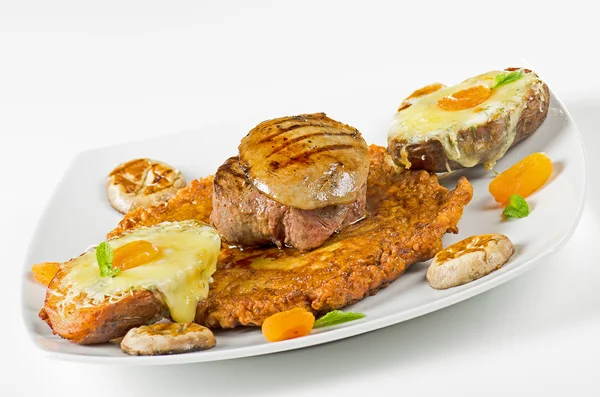 Schnitzel with potatoes to peel, mushrooms, apricots and cheese — Stock Photo, Image