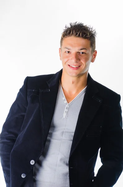 Portrait of happy young man standing against white background — Stock Photo, Image