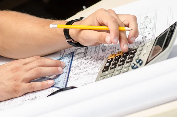 Man working with a calculator and square drawing — Stock Photo, Image
