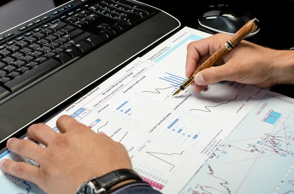 Man's hands working on business reports — Stock Photo, Image