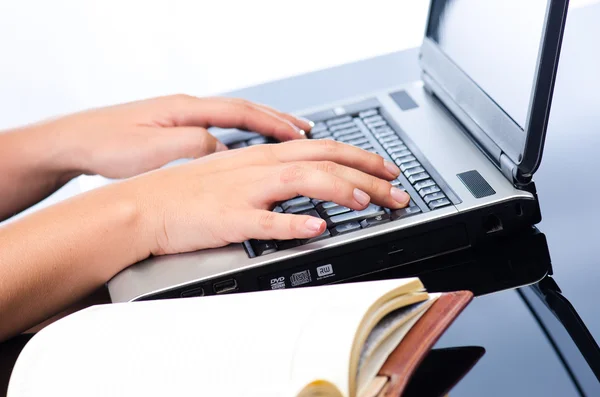 Woman's hands working on notebook keyboard — Stock Photo, Image