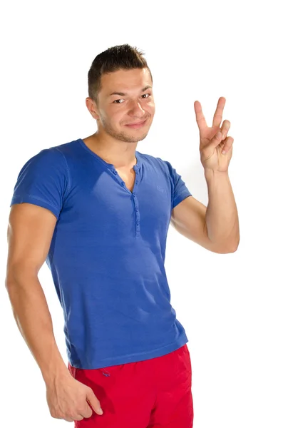 Young man showing victory sign — Stock Photo, Image