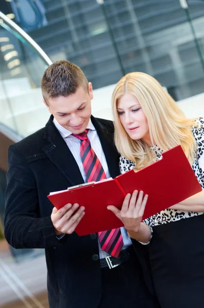 Empresario y mujer de negocios hablando sobre documentos — Foto de Stock