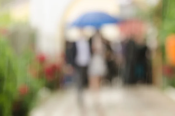 Scenery with people with umbrella blurred — Stock Photo, Image