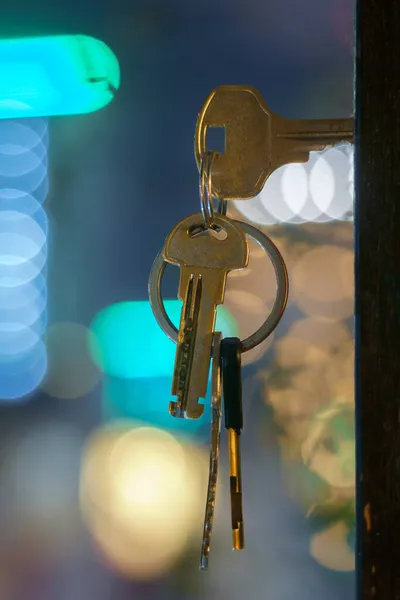 Nycklarna Med Hus Nyckelring Dörren Nyckelhålet Med Suddig Nattljus Bakgrund — Stockfoto