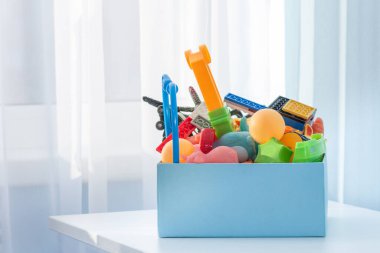 Bağış yapmak ya da geri dönüşüm için eski plastik oyuncaklarla dolu bir kutu. Boşluğu kopyala.