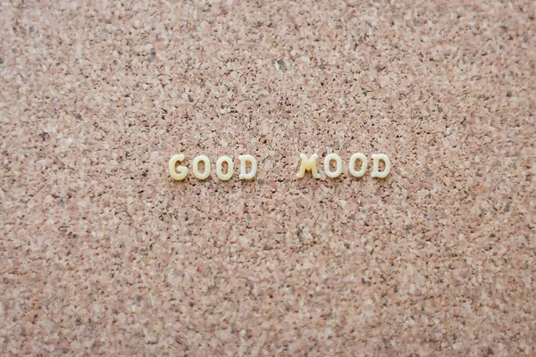 Good mood text on cork background. Mood board background. Positive phrase. Letters on cork wallpaper. Positive slogan. Creative message. Lifestyle concept. Letters on board with copy space.