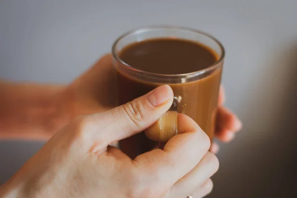 Girl holding coffee cup. Hands holding cup of morning coffee. Latte in cafe. Cappuccino cup. Espresso with milk. Hot drinks. Relax with coffee. Breakfast concept. Woman in cafeteria.