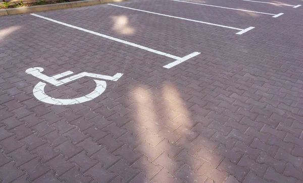 Parking lot for disabled. Parking sign wheelchair on the road. Parking space for disabled. Empty slot for car. Urban transportation concept. City traffic concept. Wheelchair road sign.