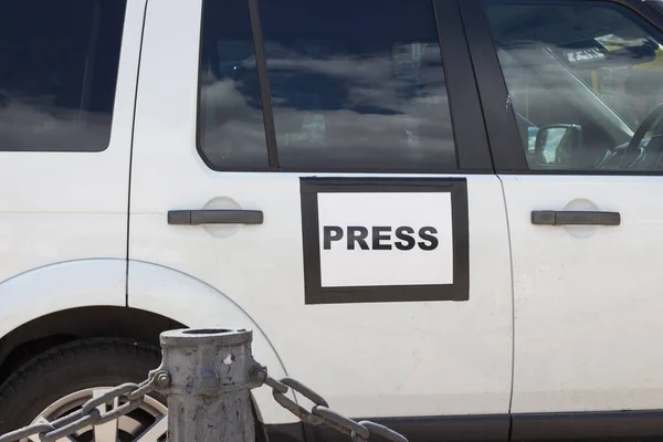 Mass media auto with sign Press in Kyiv, Ukraine. Global journalism. Documentary footage in Ukraine. News vehicle on the street. Media symbol on the car.