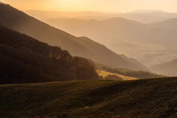 Mist and fog between valley and layers of mountains and hills at sunset, in Umbria Italy.