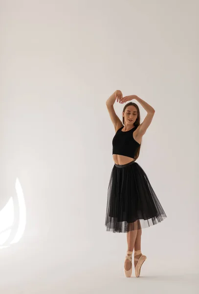 Mooie ballerina dansen in studio in zwarte jurk, hebben training. — Stockfoto