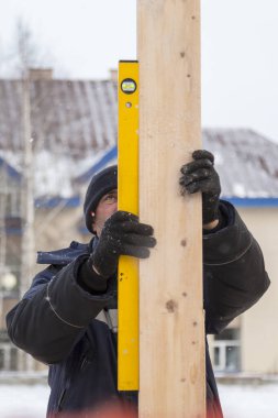 İşçi ahşap bar seviyesini ayarlar.