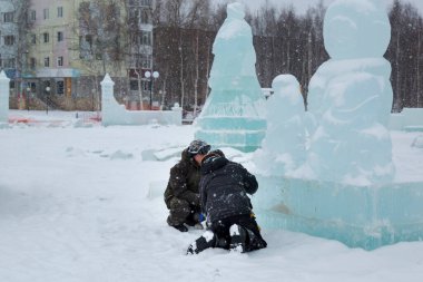 İnşaat alanındaki buz figüründeki yükleyiciler konuşuyorlar.
