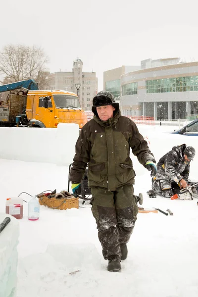 Teçhizatçı karda buz kasabasında yürüyor.