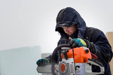 İşçi işten önce chainsaw durumunu denetler
