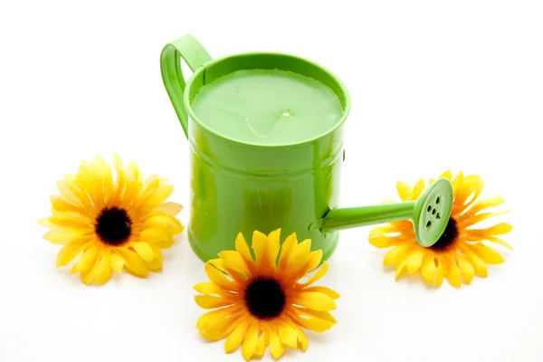 Watering can with sunflower — Stock Photo, Image